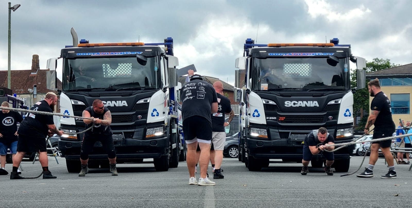 Side-by-side truck pull on Britaniacrest-branded Scania trucks at a Bad Company comp